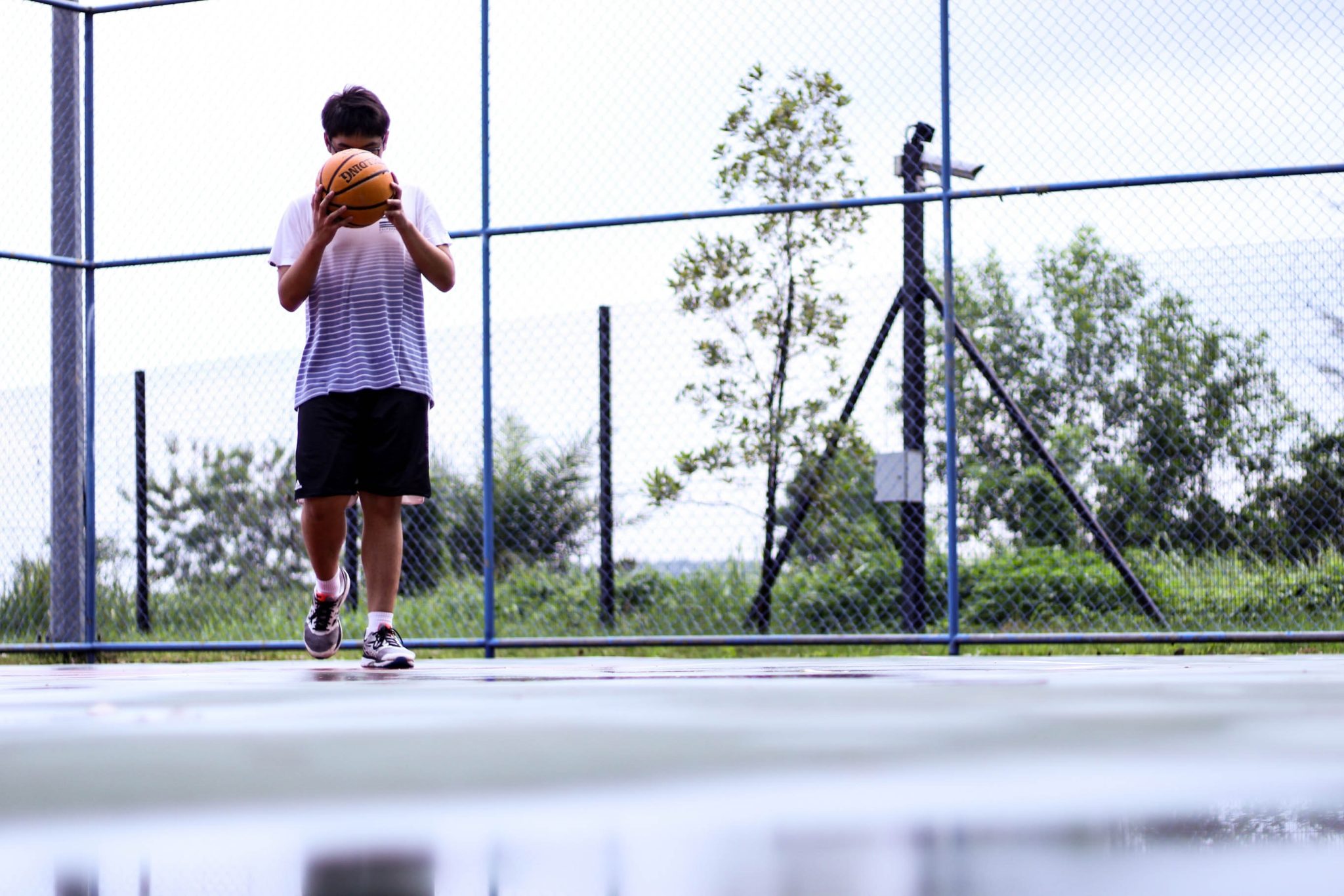 man-holding-orange-basketball-1425673